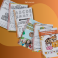 A stack of printed alphabet worksheets ready for preschool learning.